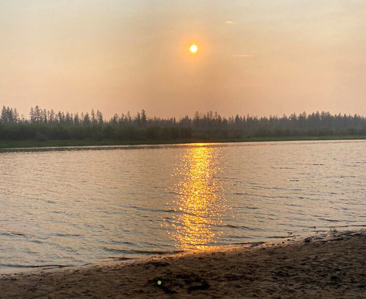 In this handout photo taken Tuesday, June 23, 2020 and provided by Olga Burtseva, a beach on the bank of Yana river is empty due to hot weather, during sunset outside Verkhoyansk, the Sakha Republic, about 4660 kilometers (2900 miles) northeast of Moscow, Russia. A record-breaking temperature of 38 degrees Celsius (100.4 degrees Fahrenheit) was registered in the Arctic town of Verkhoyansk on Saturday, June 20 in a prolonged heatwave that has alarmed scientists around the world. (Olga Burtseva via AP)