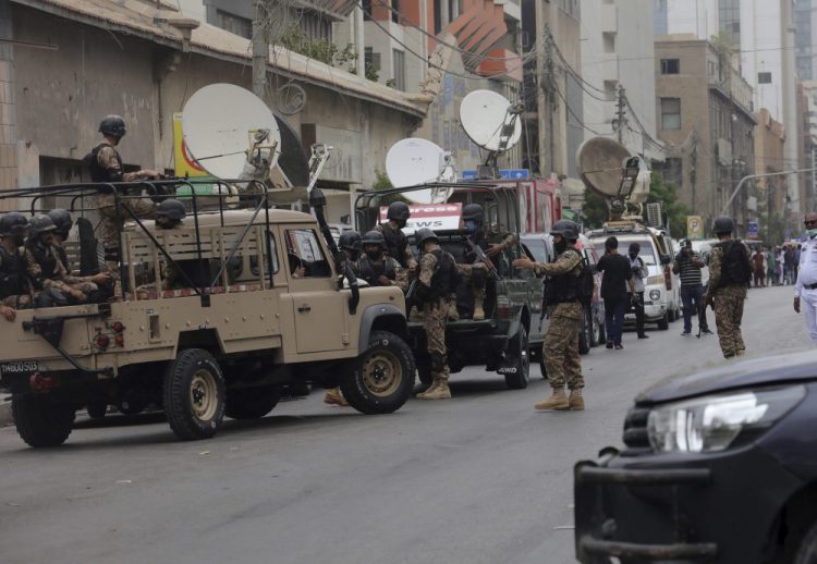 Security personnel surround the Stock Exchange Building in Karachi, Pakistan on Monday. 