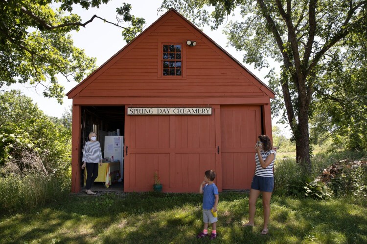 Sarah Spring, owner of Spring Day Creamery, talks to Sarah Lapine and her son Everett, 4, during a recent visit to the creamery, as part of Maine Farmland Trust statewide farm scavenger hunt. 