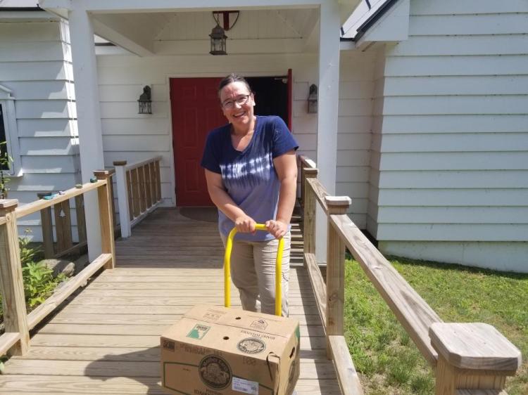 Allison Gibson-Brooks, food pantry manager at Jefferson Food Pantry, receiving the donation from Good Shepherd delivered by Eastern Traders Inc.