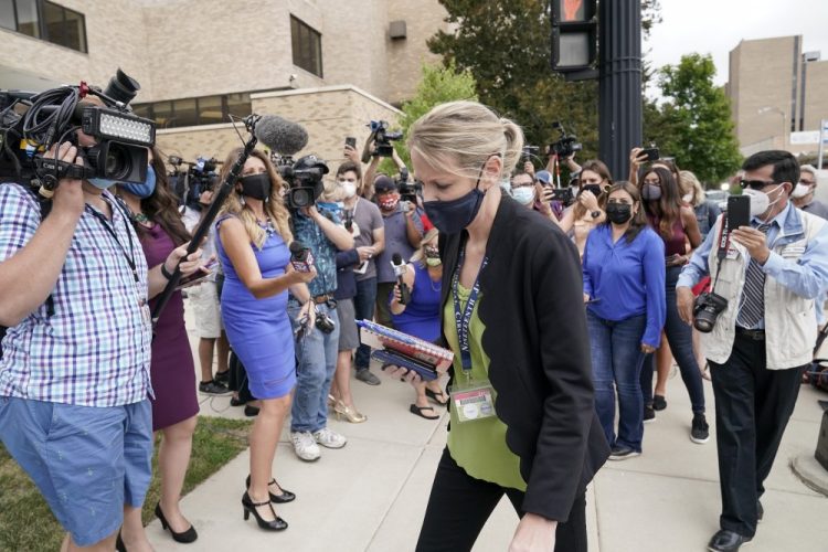 Kasey Morgan, a public information officer for the Lake County Court, walks away from reporters outside the Lake County courthouse following the extradition hearing for Kyle Rittenhouse on Friday in Waukegan, Ill. 