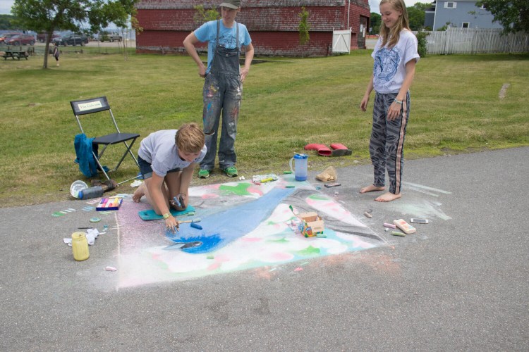 Bridget Matros, Kids & Families Programs manager at Waterfall Arts, left, with two participants in Heritage Park during the 2017 Chalk Walk.