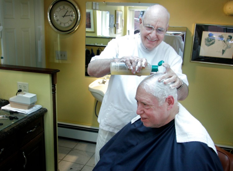 Jill Brady/Staff Photographer: Bob Mitten gives Gordon Clark of Portland, a loyal customer for 14 years, a shampoo Tuesday at Bob's Barber Shop on Fore Street in Portland.