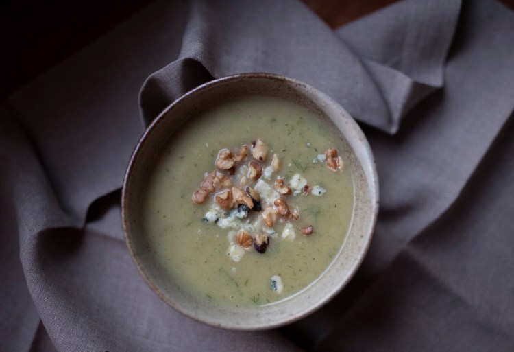 Celery soup topped with toasted walnuts and blue cheese.