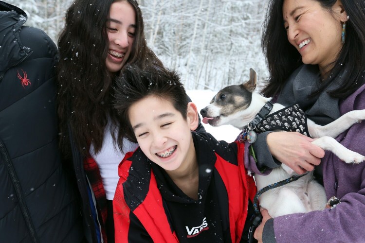 The Gerrity family with Squiggy, the 1-year-old Rat Terrier-Jack Russell mix they adopted in October from the Animal Refuge League. The family has always been a one-dog household, but decided it was a good time to add a second because Krista, right, is working from home and her kids, Ava, 13, and Renner, 10, are learning remotely three days a week. 