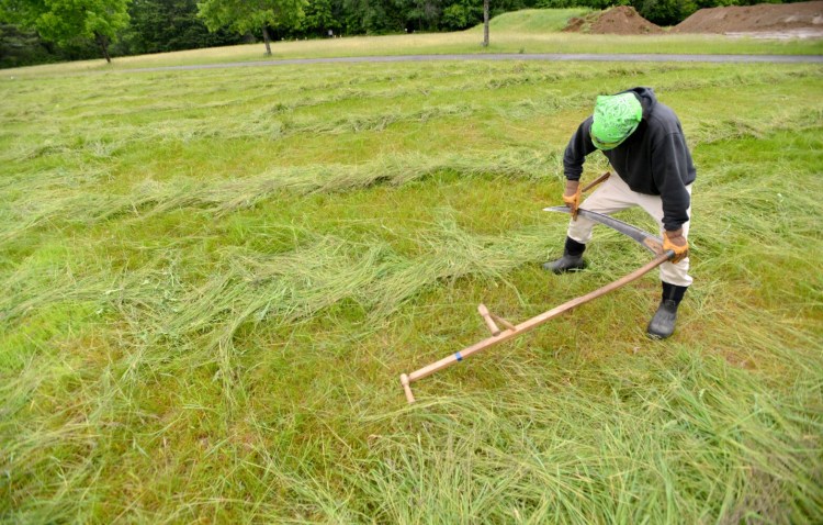 UNITY, MAINE - JUNE 17, 2017
Dan Cashore sharpens his scythe blade before cutting grass at the annual MOFGA farm and homestead day workshops in Unity on Saturday, June 17, 2017.  (Staff photo by Michael G. Seamans/Staff Photographer)