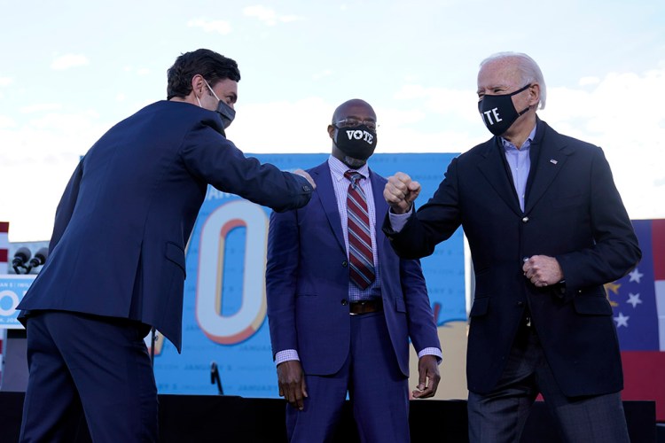 President-elect Joe Biden campaigns in Atlanta on Monday for Senate candidates Raphael Warnock, center, and Jon Ossoff, left.