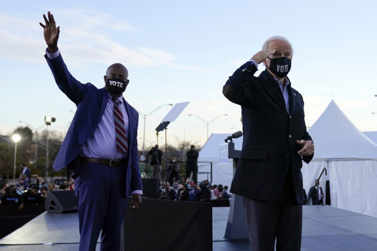 President-elect Joe Biden campaigns in Atlanta, Monday for Senate candidates Raphael Warnock, left, and Jon Ossoff. 