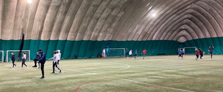 The Mt. Ararat indoor track team splits into two groups to accommodate social distancing during their practice on Tuesday at the Topsham Indoor Sports Complex in Topsham.