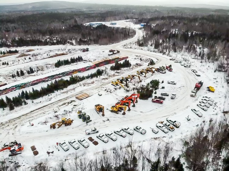 Wood-harvesting equipment, excavators and other machines that will be used to clear the corridor for the New England Clean Energy Connect project are arrayed Friday at the so-called Marshall Yard, off Route 201 near West Forks. At the rear, massive stacks of wooden erosion-control mats await transport into the forest.