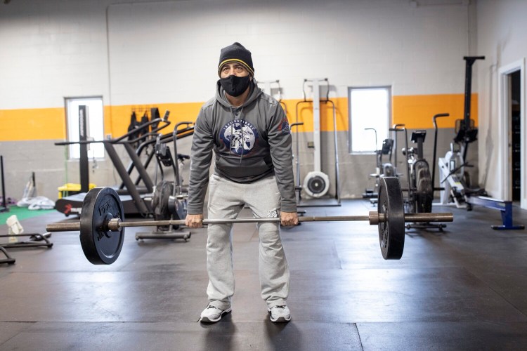 FALMOUTH, ME - JANUARY 29: Tony Napolitano works out at Beyond Strength on Friday, January 29, 2021. The gym lets 10 people work out in  the building at once and has people register for their slot of time ahead of time online. Napolitano joined the gym recently after working out at home and outside through most of the pandemic. ÒIt was much harder to keep doing after it got cold,Ó he said. ÒIÕd much rather come to a gym.Ó (Staff photo by Brianna Soukup/Staff Photographer)