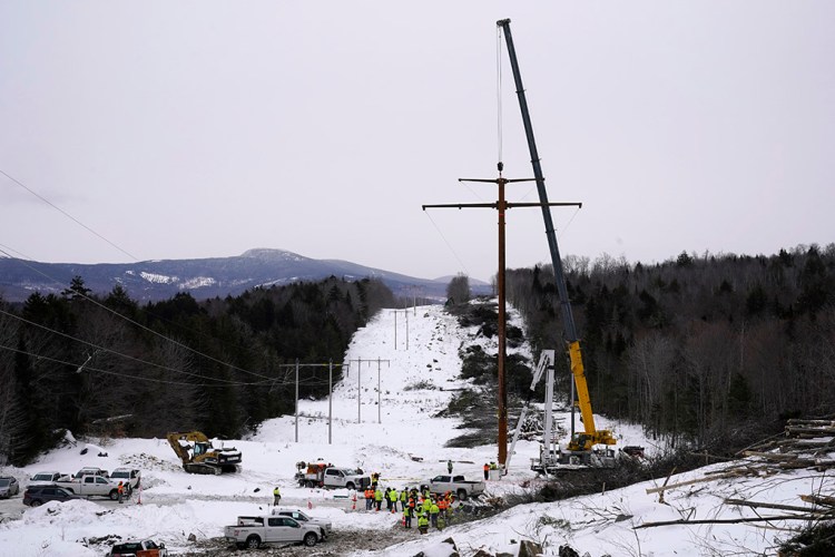 The first pole of Central Maine Power's controversial hydropower transmission corridor is prepared for installation Tuesday near The Forks. The pole was erected on an existing corridor that had been widened near Moxie Pond.