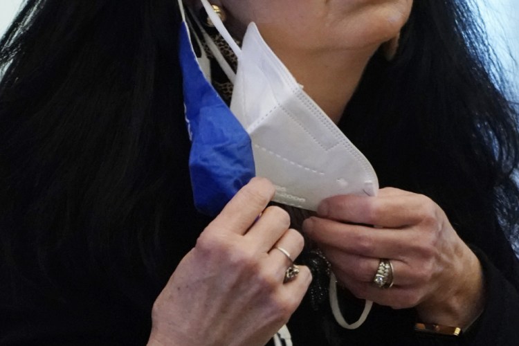 A state legislator adjusts her face masks while asking a question at the Capitol in Jackson, Miss. on Feb. 4. A government study released on Wednesday finds that wearing two masks can better than one, in protecting against coronavirus infection. 