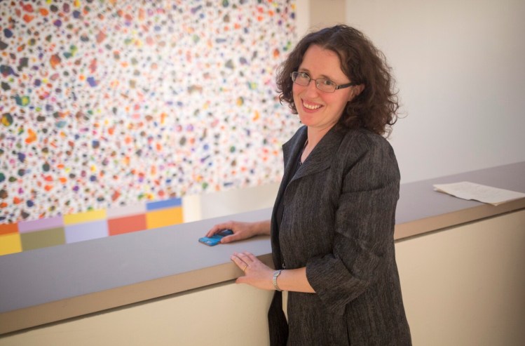 PORTLAND, ME - SEPTEMBER 16: Jessica May, chief curator at the Portland Museum of Art, in front of A Midsummer Night's Dream, 2016, ink on latex saturated cellulose, by Tim Rollins and the K.O.S. (Kids of Survival). The work was recently acquired for the museum's permanent collection. The Tim Rollins and the K.O.S. exhibit is a survey of the groupÕs work in a variety of media and will be on display till December 31. Rollins was born and raised in Pittsfield, Maine. (Photo by Brianna Soukup/Staff Photographer)