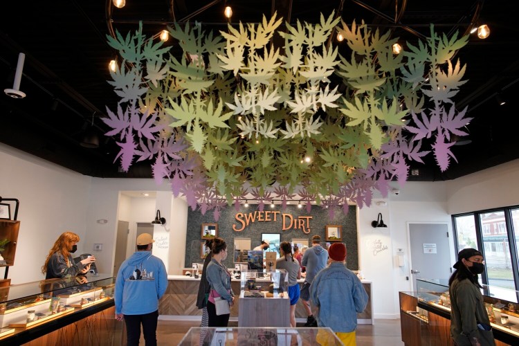 Customers place orders Tuesday at Sweet Dirt, an adult use cannabis dispensary in Portland, on the first April 20, also known as "4/20" or "stoner Christmas," for legal adult-use cannabis in Maine.