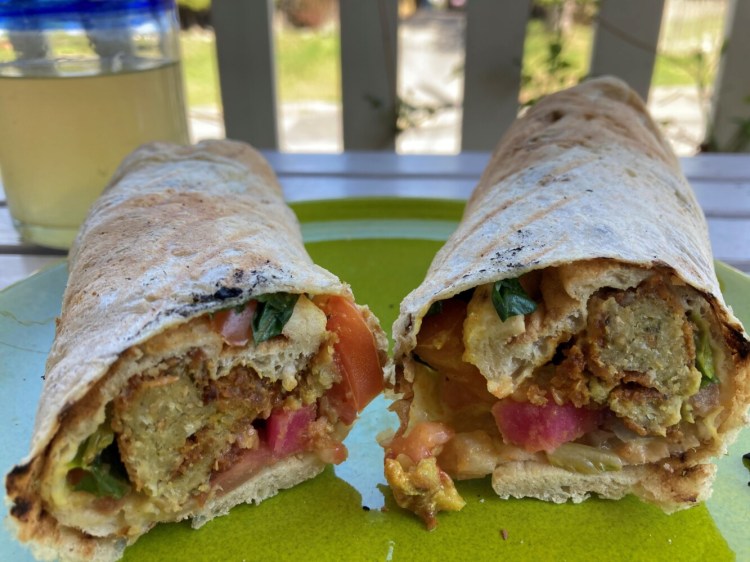 The standard falafel, left, pictured next to Dina's Falafel, which adds fried potatoes to the sandwich. 