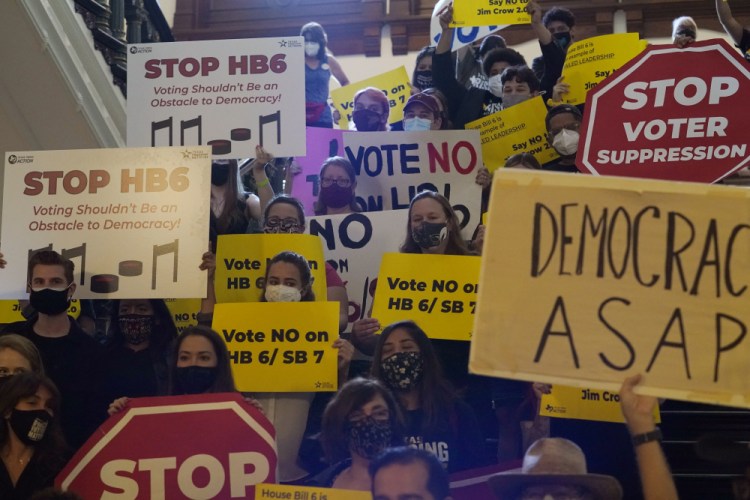 A group opposing new voter legislation gathers May 6 outside the House chamber at the Texas Capitol in Austin.  

