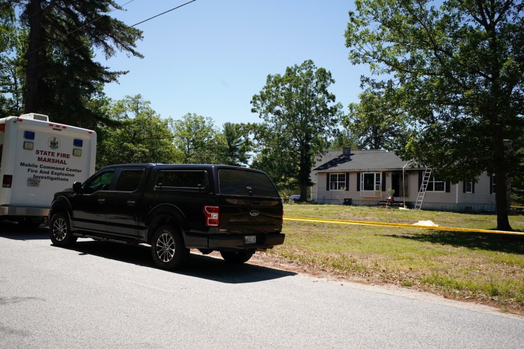 Police and fire investigators were gathered at a home on Hardscrabble Road in Limington where two adults were found dead and the building was damaged in a fire on Thursday morning.