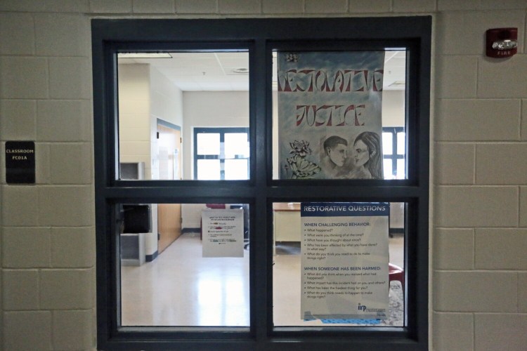 A window looking into a classroom at the Long Creek Youth Development Center where restorative justice is taught.