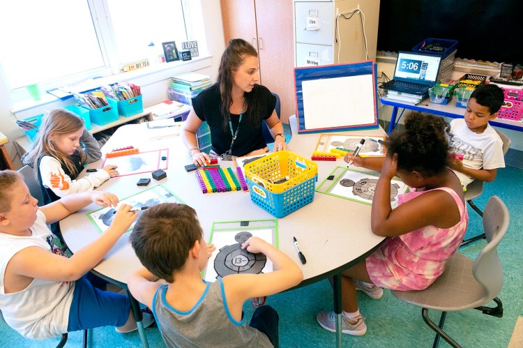 First-grade teacher Jessica Gauthier works with her students during a math lesson Thursday at Farwell Elementary School in Lewiston. Students attend Summer STEM Camp four days a week over the summer.