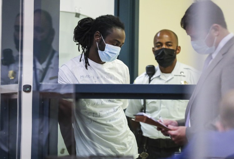 Conald Pierre is arraigned in Malden District Court on Wednesday. Pierre is one of  11 people charged in connection with an armed standoff along a Massachusetts highway last weekend.