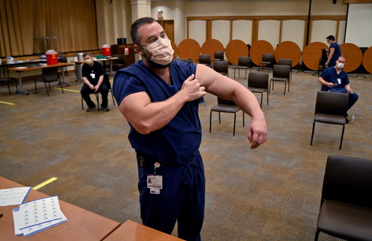 Brad Butcher, a Pittsburgh physician, prepares to get his second coronavirus vaccine in January. MUST CREDIT: Washington Post photo by Michael S. Williamson