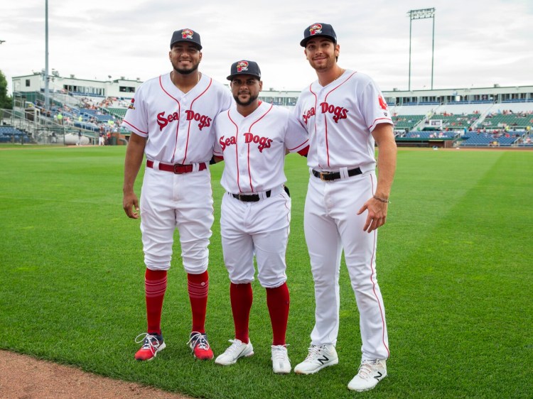 Portland Sea Dogs teammates Denyi Reyes, left, Roldani Baldwin and Triston Casas, right, competed in the Tokyo Olympics. They returned to Hadlock Field on Tuesday night.