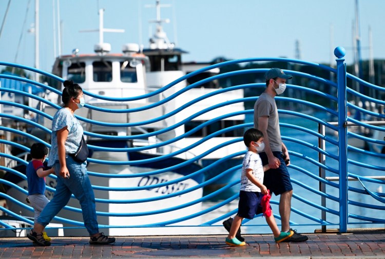 PORTLAND, ME - AUGUST 24: Pedestrians walk along Commercial St. in Portland Tuesday, August 24, 2021. (Staff Photo by Shawn Patrick Ouellette/Staff Photographer)