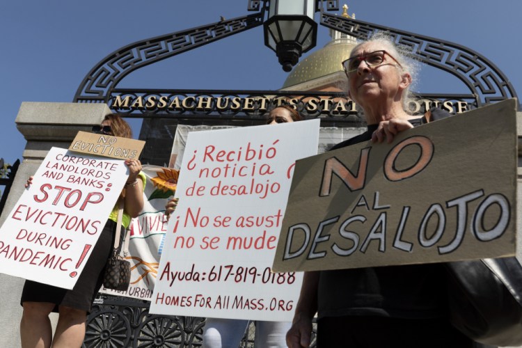 People from a coalition of housing justice groups protest evictions during a news conference outside the Statehouse on Friday in Boston. More than 3.6 million Americans are at risk of eviction. 