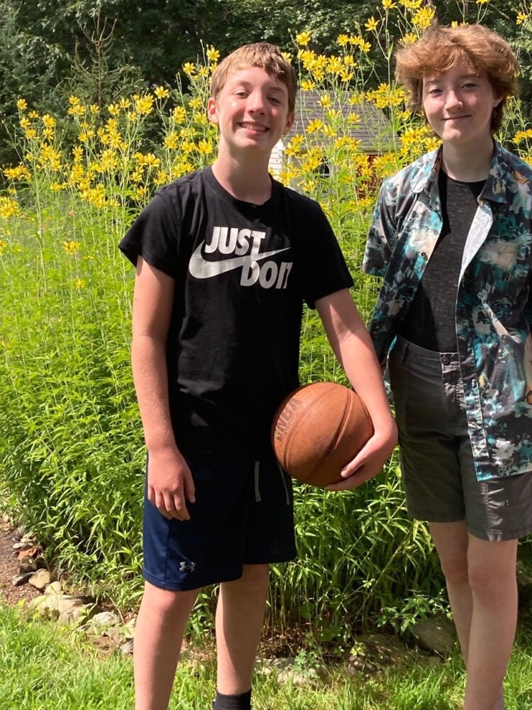 The coreopsis in columnist Tom Atwell's garden towers over his grandchildren, James, 12, and Alana, 14. In late summer, it's nice to have a garden focal point.