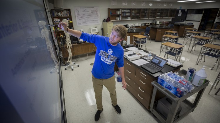 Johnson County High School teacher Michael Caneege teaches anatomy to his students online on Friday in Wrightsville, Ga. With 40 percent of students in quarantine or isolation, the Johnson County district shifted last week to online instruction until Sept. 13.