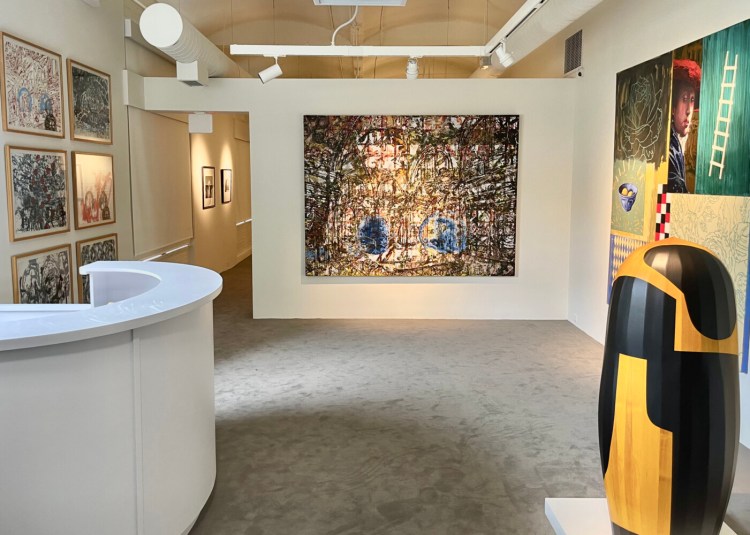 The Friends Gallery at the expanded Zillman Museum of Art, with paintings by French-American artist John Bailly (far wall), a painting titled "Harlequin's Romance" by James Linehan and, in the foreground, the sculpture "Parkway" by Steve Bartlett.