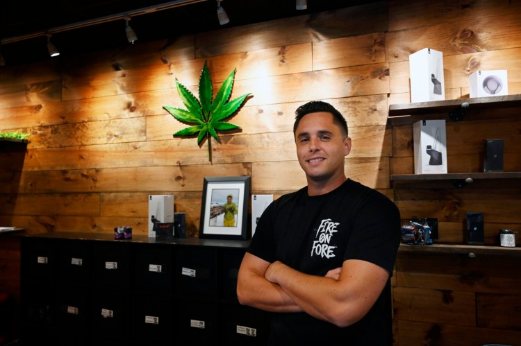Tom Mourmouras, co-owner of Fire on Fore recreational cannabis shop in the Old Port, stands inside the store on Wednesday. Fire on Fore is the popular tourist area's first recreational cannabis storefront.