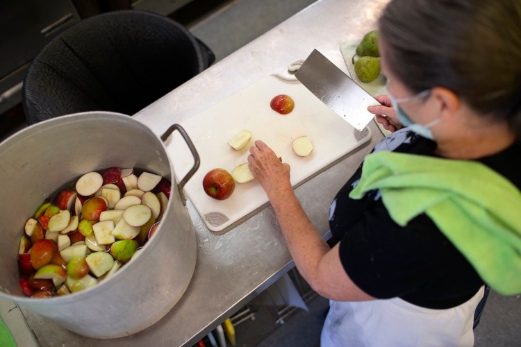 PORTLAND, ME - SEPTEMBER 19: Lindsay Knapp makes applesauce from donated apples and pears to be distributed to local food banks and school programs. Knapp has started an organization called Forgotten Orchard that collects unwanted either gives them to programs that need them or processes them into applesauce or fruit leathers. (Photo by Derek Davis/Staff Photographer)