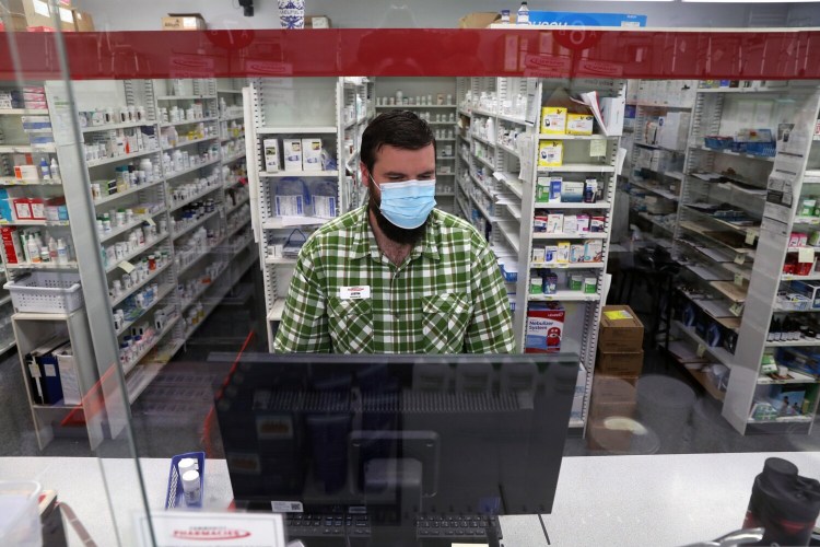 SACO, ME - SEPTEMBER 16: Justin Richards, a pharmacist at Community Pharmacy of Saco, works behind the counter on Thursday. He said the store receives just 12 packages of Abbott's BinaxNOW COVID-19 Ag Card Home Tests per week on Mondays, and they sell out quickly. "It's a big bummer because everybody's looking for one," he said. The pharmacy sells them for $39.79. (Staff photo by Ben McCanna/Staff Photographer)