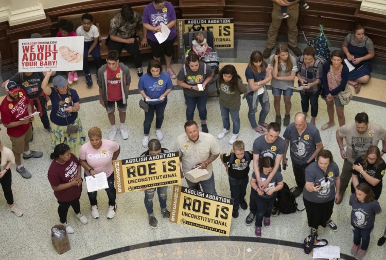 Pro-life demonstrators gather in the rotunda at the Capitol while the Senate debated anti-abortion bills March 30 in Austin, Texas. Even before a strict abortion ban took effect in Texas this week, clinics in neighboring states were fielding more and more calls from women desperate for options. 