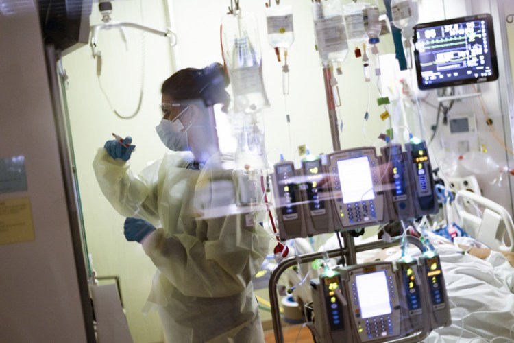 Ann Enderle, R.N., attends to a COVID-19 patient in the medical Intensive care unit at St. Luke's Boise Medical Center in Boise, Idaho, in August.  