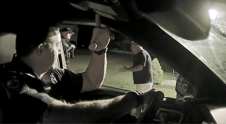 Captured on police video, South Berwick police Chief Dana Lajoie, right, tells Berwick police Sgt. Jeff Pilkington, center, on July 20 that Berwick police officers who drove onto his private road were trespassing. The Lajoies tried to press charges against police for driving briefly down the road.

