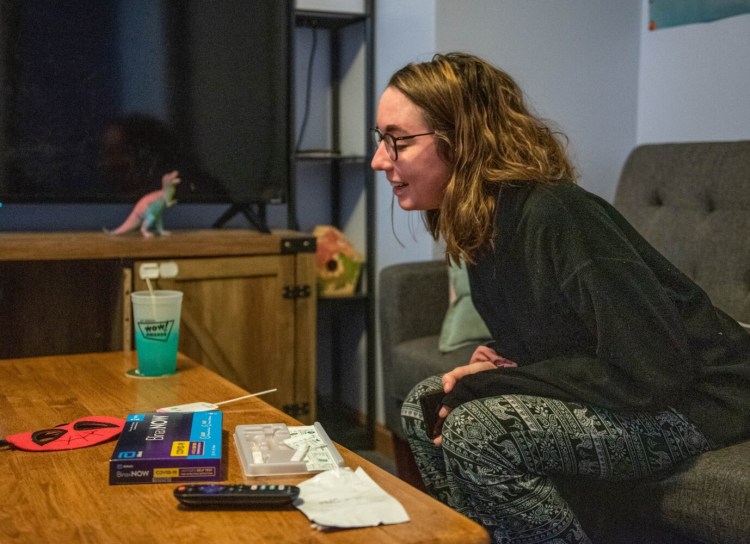 Nicole Bonnell reacts with relief Wednesday to her negative at-home COVID-19 test at her home in Auburn. Her son's pool in pre-school tested positive, resulting in a 10-day quarantine. Bonnell took the test after coming down with cold symptoms.