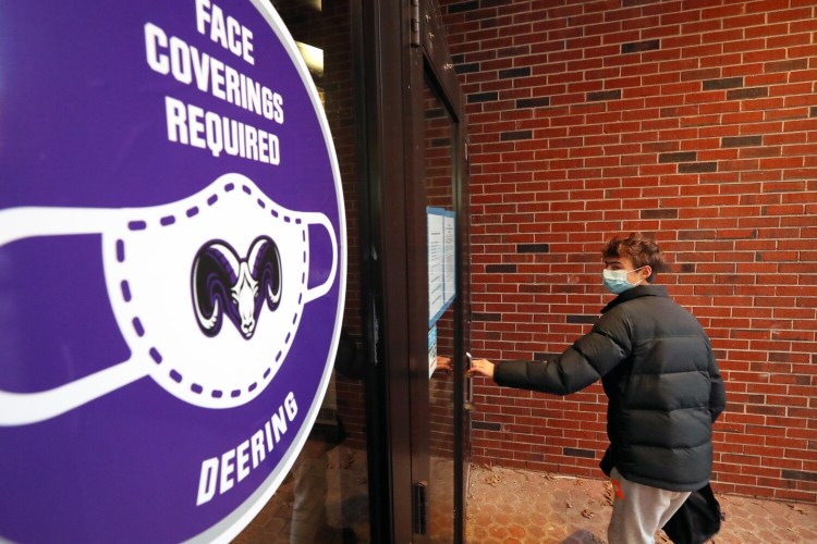 Daniel Landry enters the gymnasium at Deering High School, where he is a sophomore. Landry said he knows three students who are out of school with COVID-19. Despite the outbreaks in city schools, Landry said he's "not super worried." 