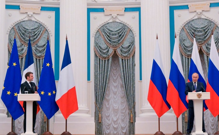 Russian President Vladimir Putin, right, and French President Emmanuel Macron attend a joint news conference following their talks in Moscow, on Monday. According to Macron, Putin also said there won’t be any Russian “permanent (military) base” or “deployment” in Belarus.