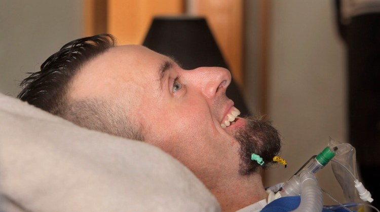 Nick Stanley smiles as he listens to the rapper Spose perform at his home in 2014.