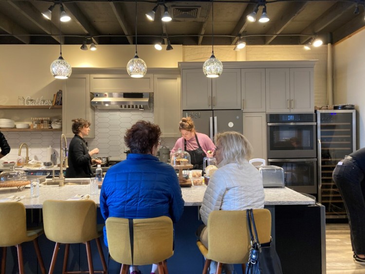 The chef at work, with customers seated at the kitchen counter at The Maker's Galley.