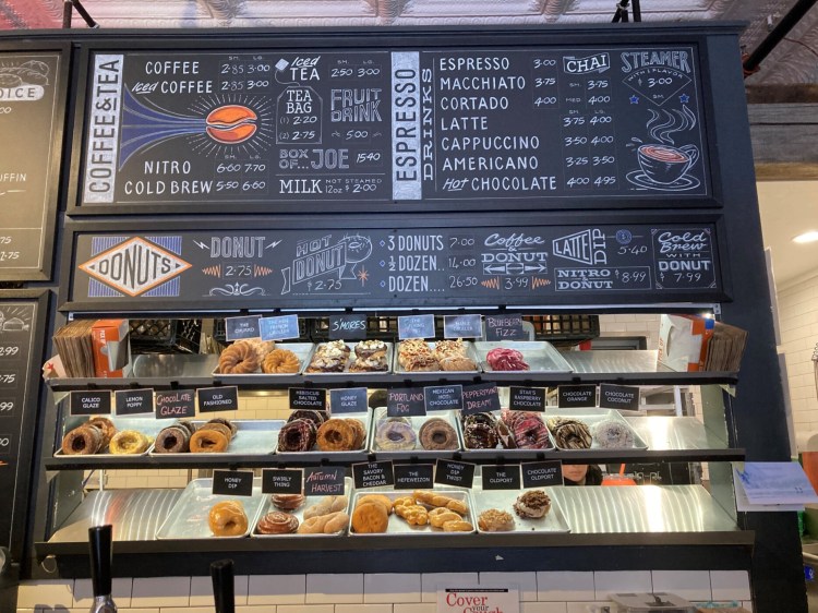 The day's selection of donuts and part of the menu at the ordering counter at HiFi Donuts. 