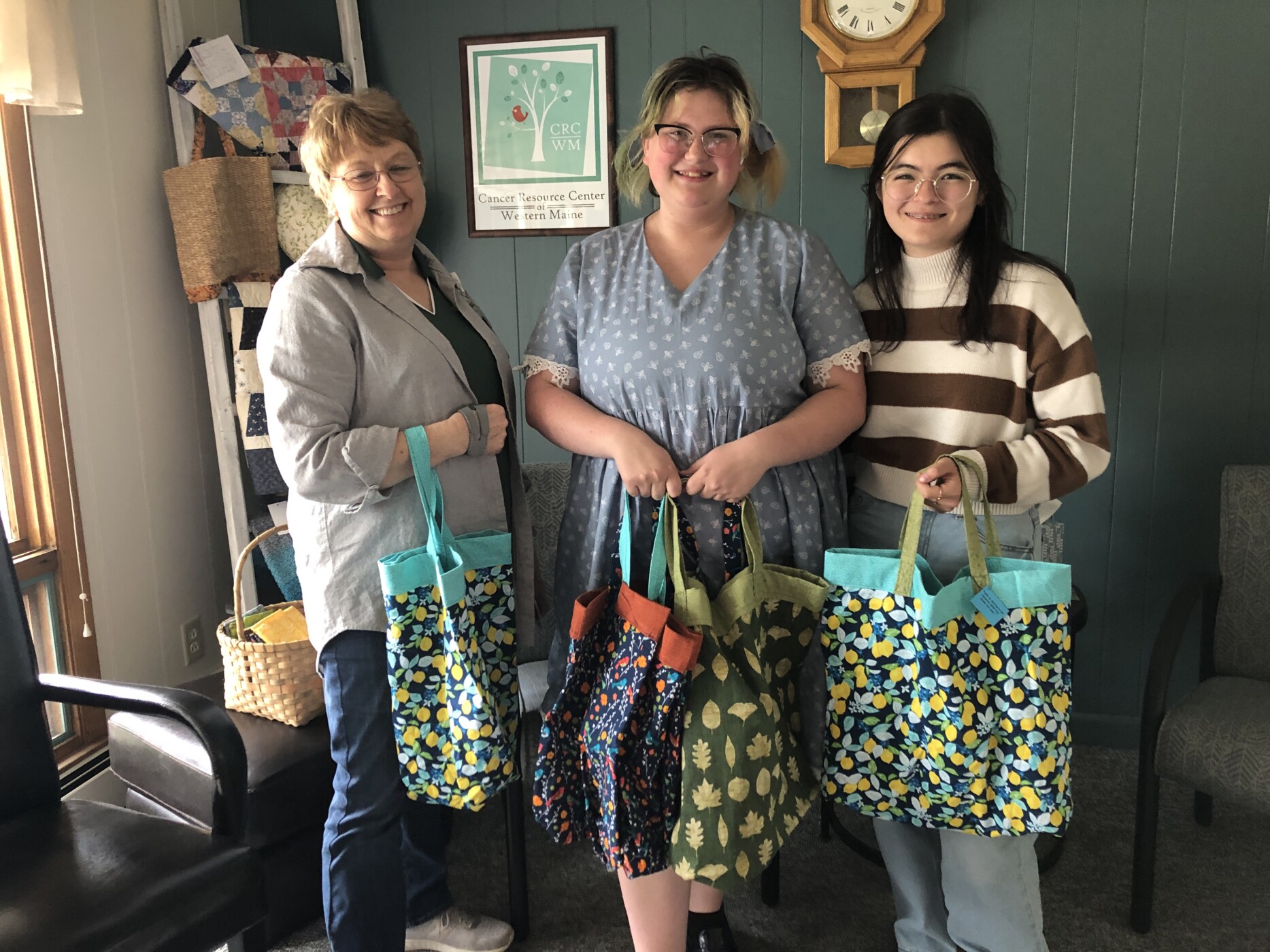 The Cancer Resource Center of Western Maine recently received a variety of comfort items for cancer patients, which were designed and sewn by Oxford Hills Technical School students in the Fashion Design Program, led by instructor Lori Millett.  The students participated in this after-school endeavor, which also helped them earn community service points towards their graduation requirement. From left are Lori Millett, OHTS fashion design instructor; Emily Thibodeau; Nanami Daggett. Absent from photo is Jaxton Stein.