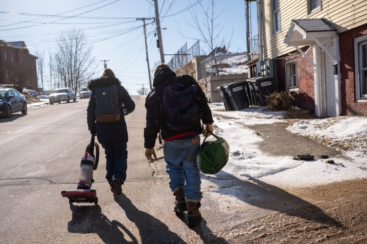 Alex Southworth, right, walks with a friend to a pawn shop on Feb.18 with a vacuum cleaner and a tent that had been donated to them in hopes of pawning them. Southworth is recently homeless and struggling to figure out how to get back into a better living situation.