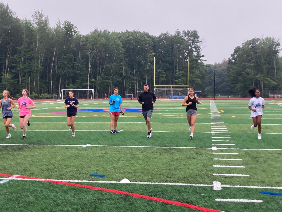 Kevin Flaherty, head coach of Mt. Ararat girls' soccer, runs with his team during an early morning summer conditioning session on Wednesday, July 31.